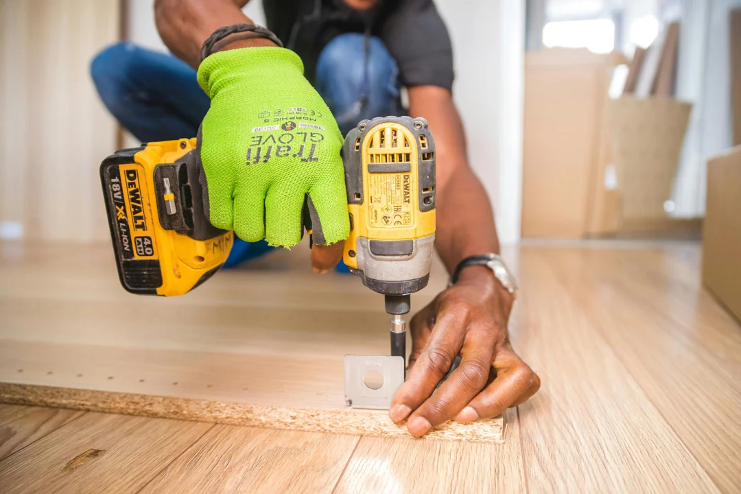 Hands carefully fastening a fitting during property maintenance